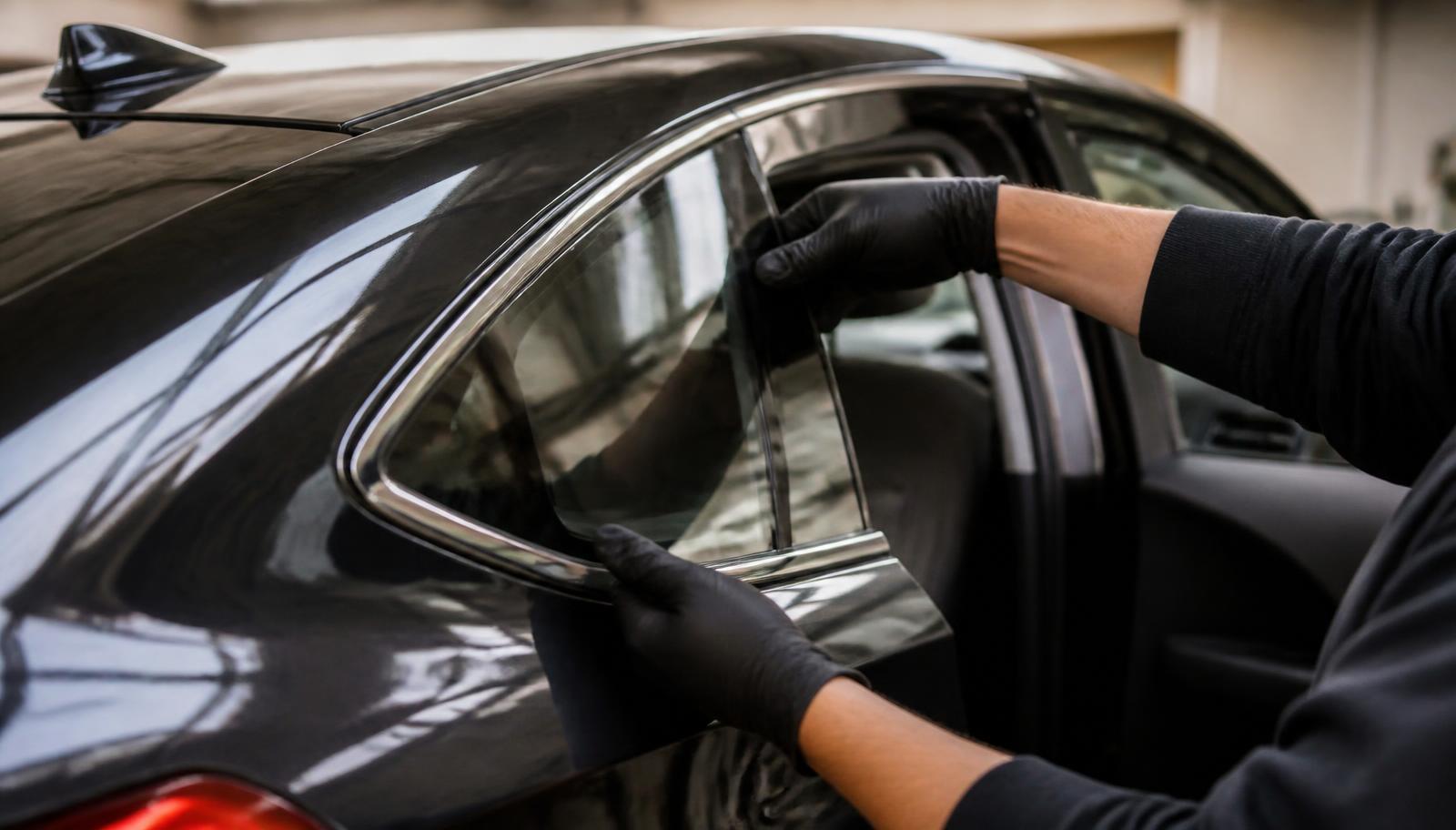 Close up of a car quarter glass being replaced